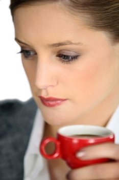 Woman holing cup of espresso