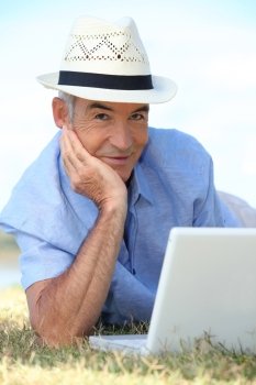 Senior man using his laptop