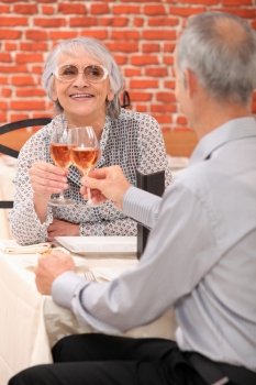 Mature couple toasting with rose wine