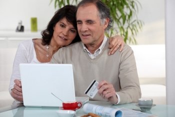 Middle-aged couple shopping on-line