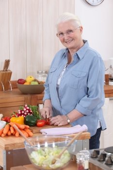 Older woman chopping vegetables
