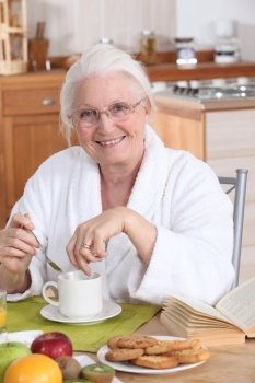 granny in the kitchen having breakfast