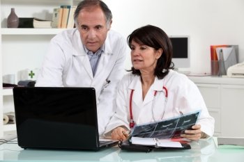 male and female doctors with laptop