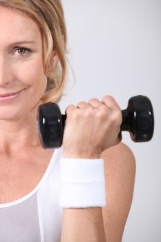 Closeup of woman with dumbbell