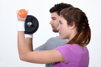 couple lifting weights in profile