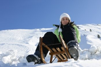 Girl on a sled in mountain