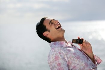 Man laughing by the water’s edge