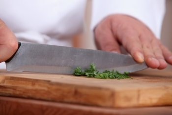 Chef chopping herbs