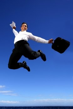 Overjoyed businessman jumping in the sky