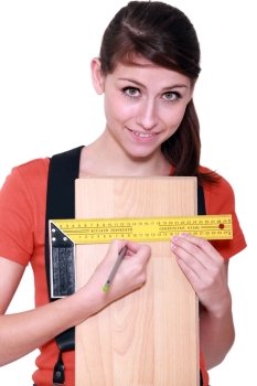 Woman measuring width of laminate flooring