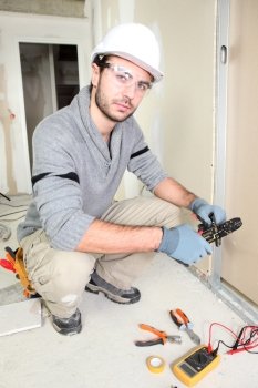 Electrician wiring up a home
