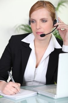 Woman using a headset at her laptop