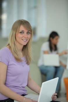 Young woman sitting with a laptop on her lap
