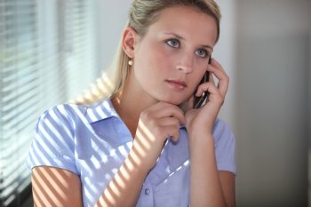 Young woman using a cellphone in an office