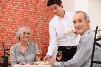Old couple having meal in restaurant