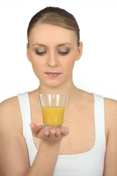 Woman with glass of orange juice in hand
