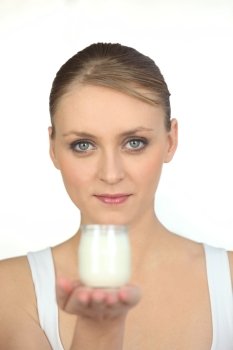 Young woman with yoghurt on a white background