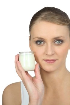 Blond woman holding yogurt