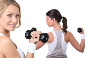 Women lifting weights together