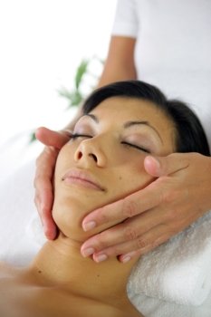 Woman receiving face massage
