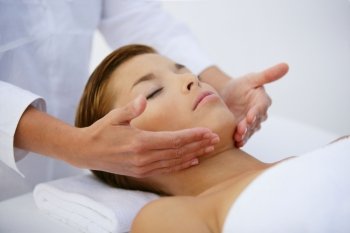 Young woman relaxing during facial massage