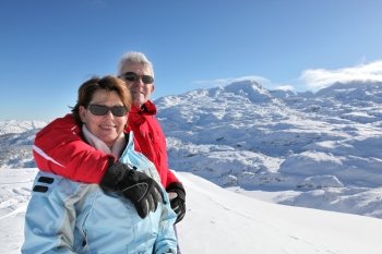 Middle-aged couple on skiing holiday