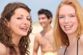 Closeup of smiling young people having fun on the beach