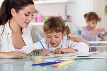 Woman and child colouring at a desk