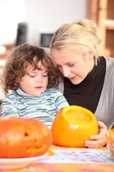 Mother and son carving pumpkin