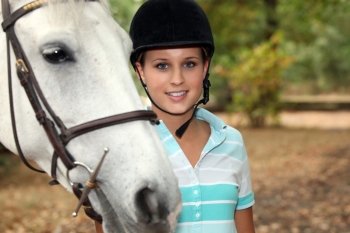 Blond teenager stood with horse