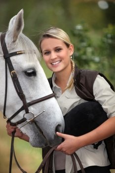 Blond teenage girl with horse
