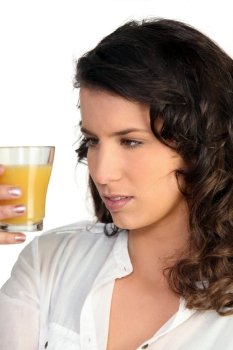 Woman observing orange juice
