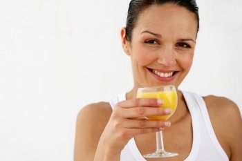 Brunette enjoying glass of orange juice