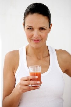 Brunette holding glass of tomato juice
