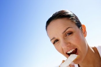 Woman eating a rusk with butter