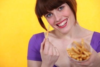 young woman eating French fries
