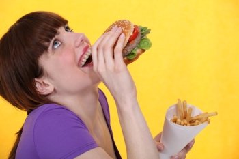 girl ecstatic over hamburger meal with fries