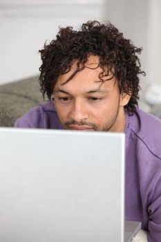 Metis man using laptop at home