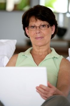 Portrait of mature lady with laptop