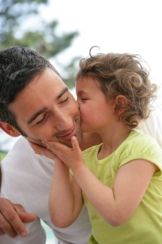 little girl kissing her father