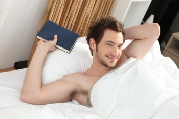 man relaxing in his bed