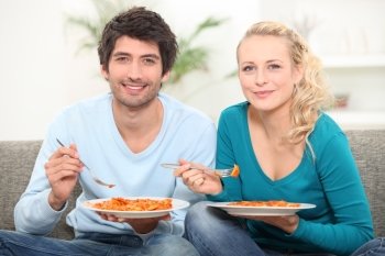 couple having dinner on the couch