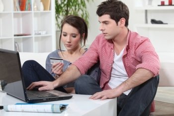 Young man and young woman making shopping online