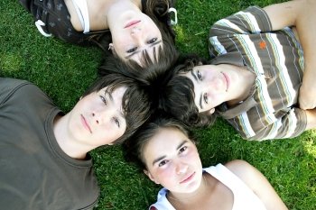 Teenagers lying in the grass