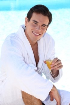 Young man drinking a glass of orange juice