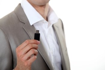 Businessman holding USB key