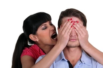 Woman covering a man’s eyes