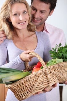 Husband looking at wife with vegetable basket.