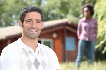 Couple stood in front of holiday home