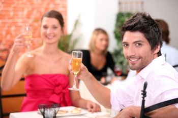 Couple toasting in restaurant